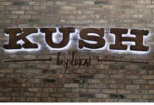 Picture of electric lighted sign for KUSH letters