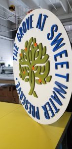Picture of Round Sign with Raised Lettering and a Tree for Sweet Water Preserve